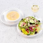 large greek salad bowl of avgolemono soup with white wine 150x150